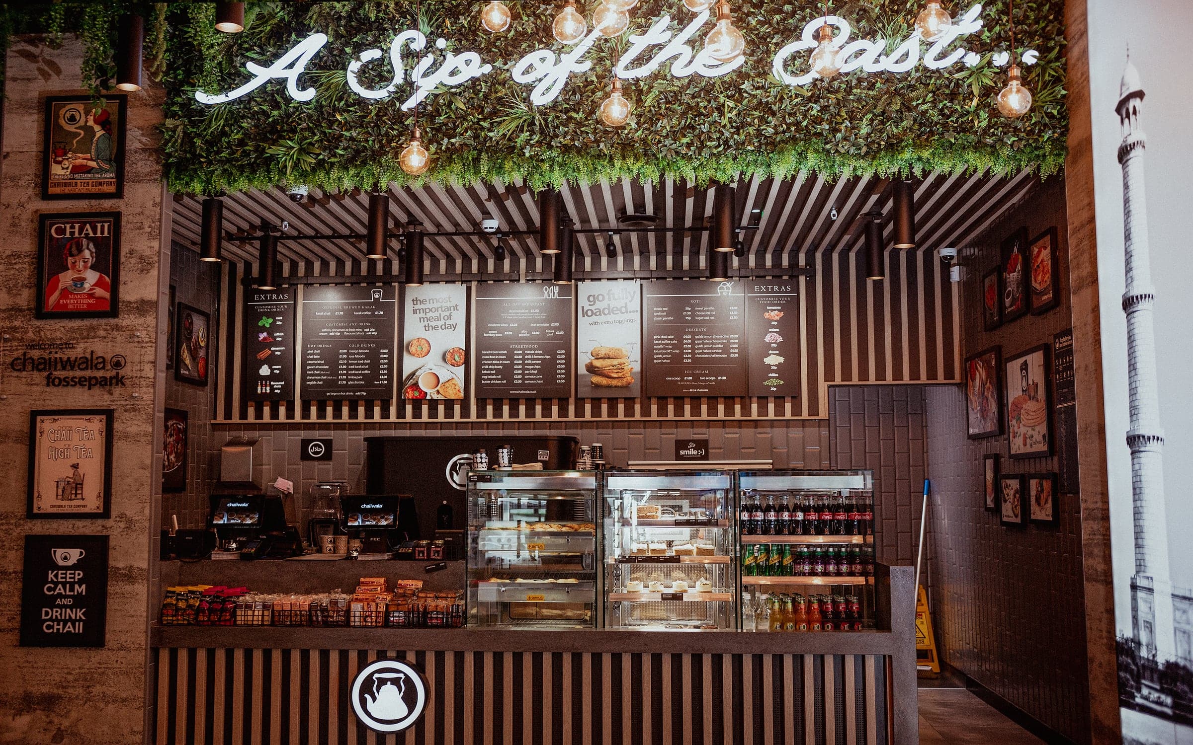 a chaiiwala interior with neon "a sip of the east" signage