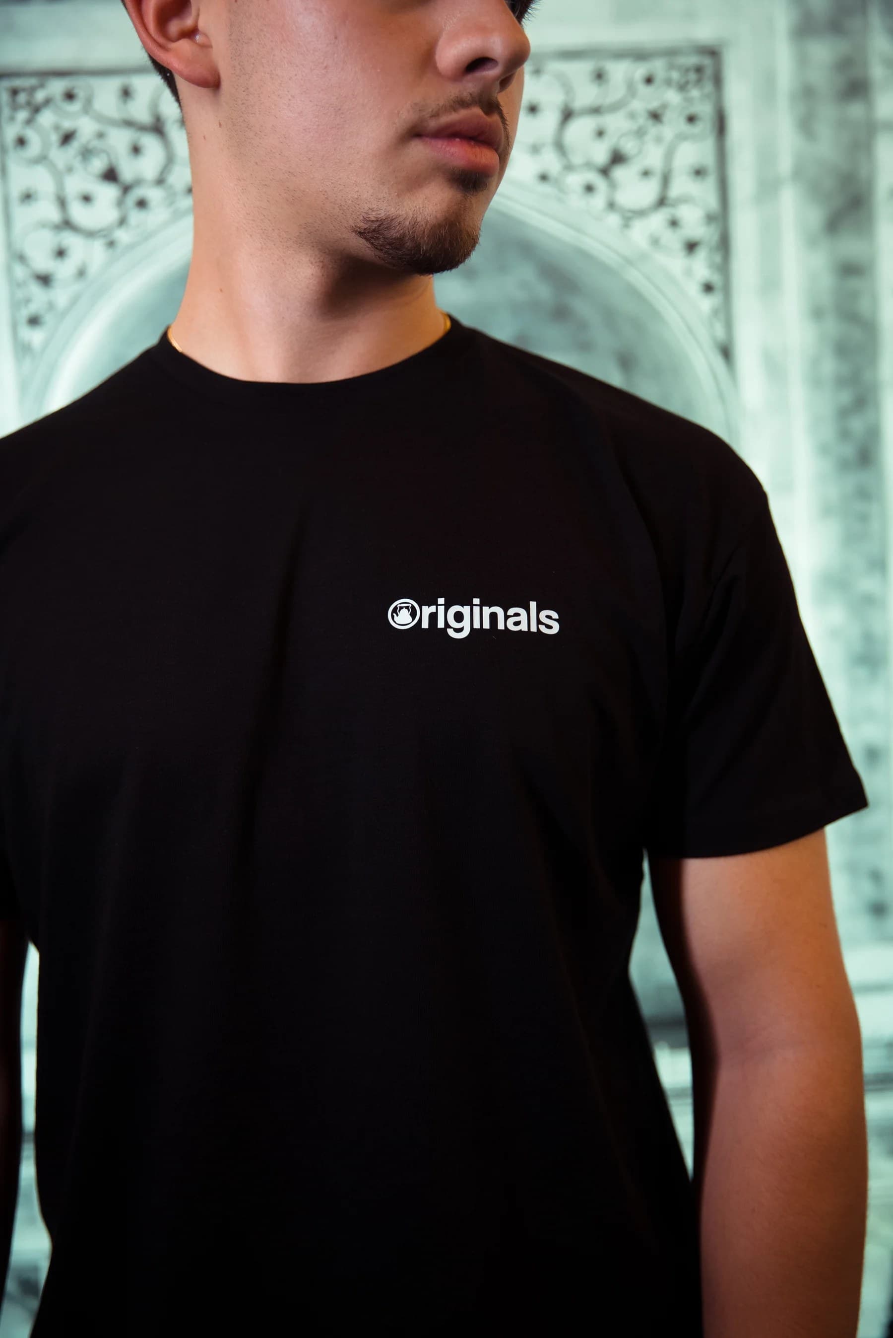 a chaiiwala team member wearing an originals tee inside a chaiiwala café